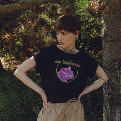 Woman model wearing Bat Reputation crop top from Chaotic Kittens in the nature.