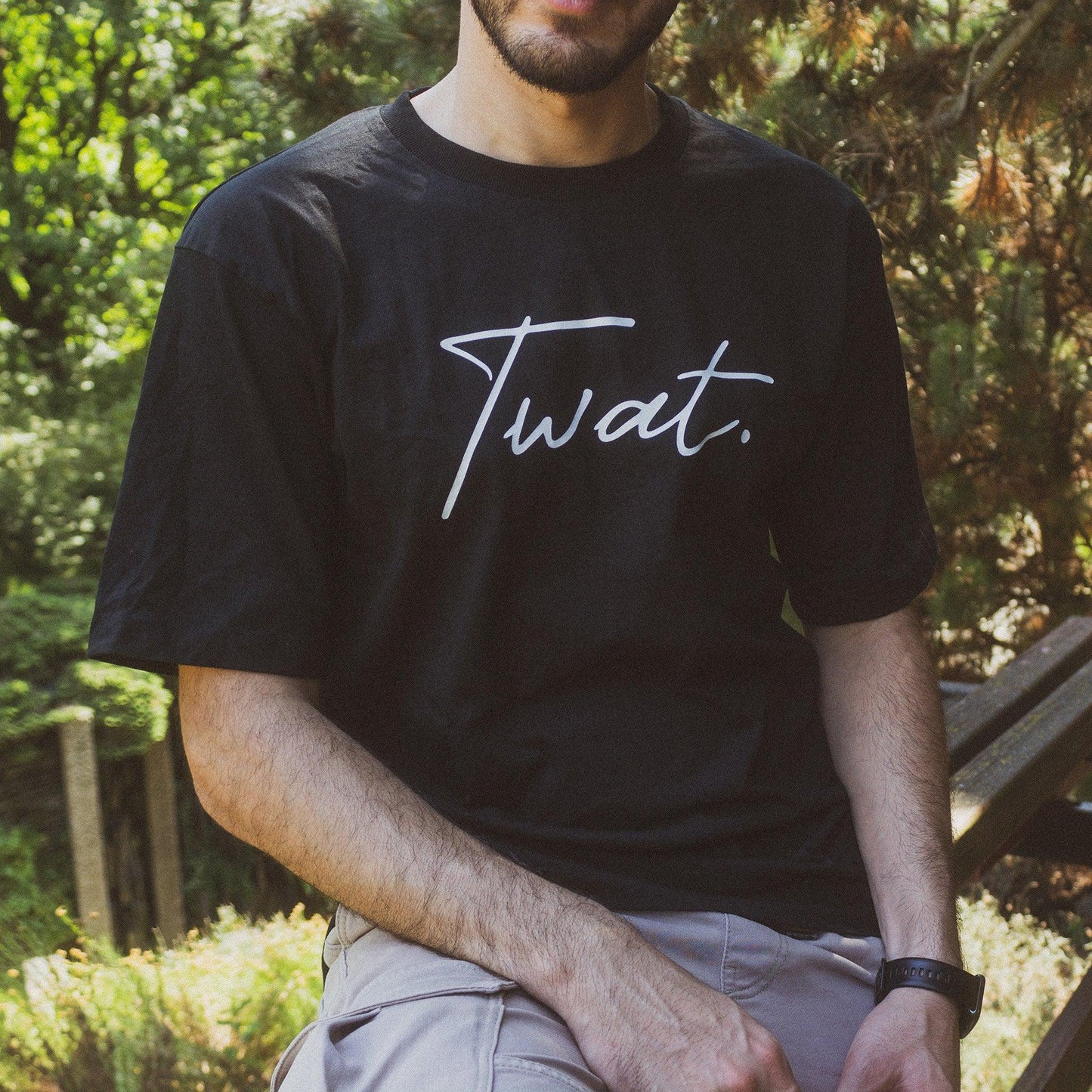 Model wearing twat oversized tshirt in nature.